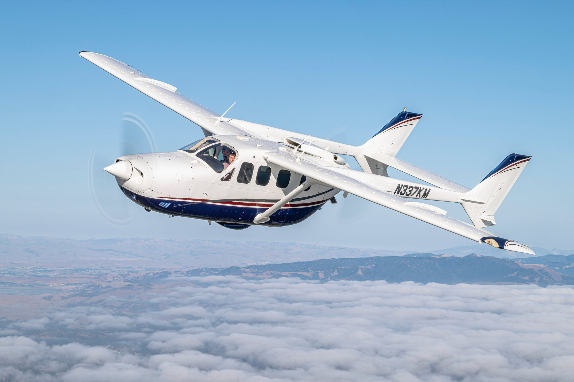 Cessna Skymaster above a cloud layer